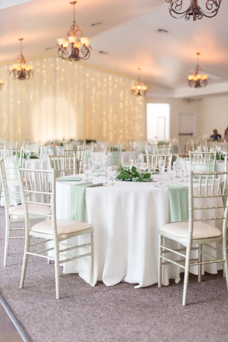 The same banquet room with a curtain of warm lights hung behind the head table