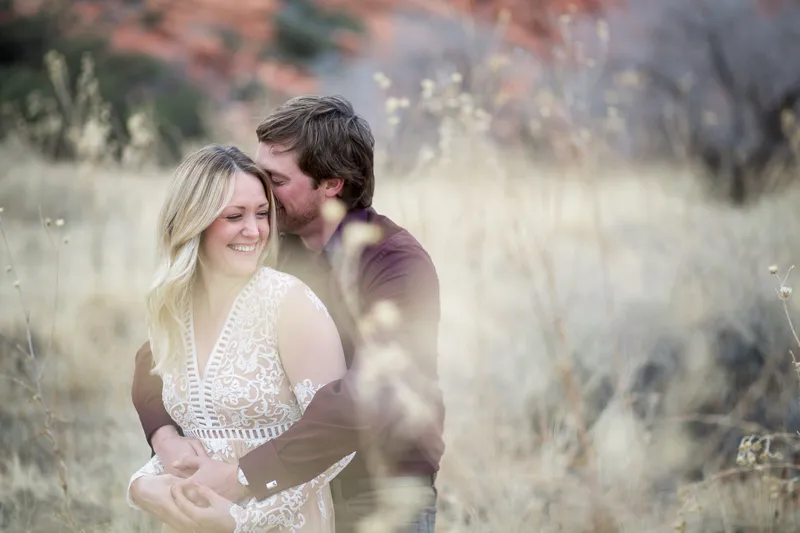 Couple laughing together in a golden desert field outside Las Vegas