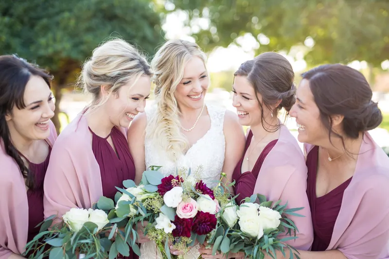 Bride laughing with her bridesmaids in the warm evening light of a Las Vegas summer wedding