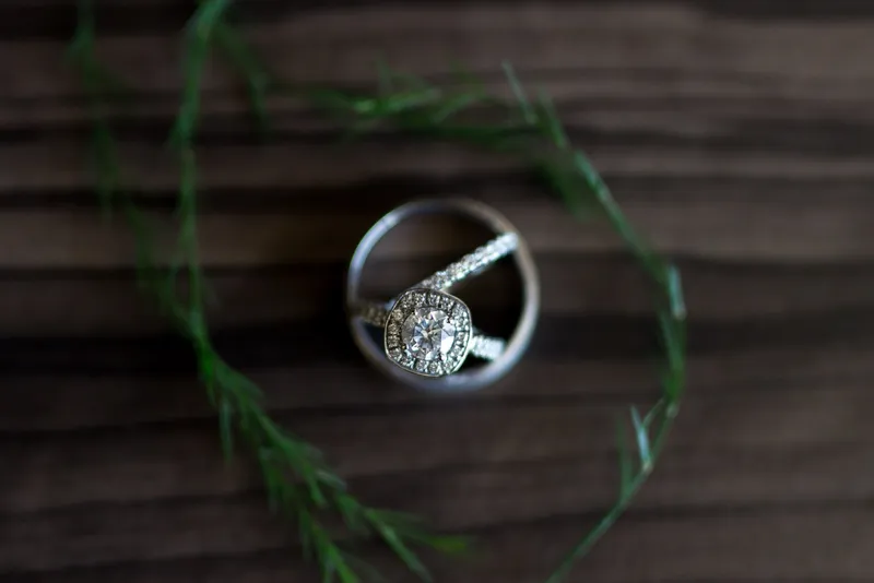 The rings on dark wood inside a small loop of greenery