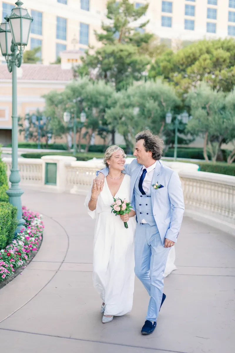 The two of them laughing as they walk the flower lined curve of the front walkway