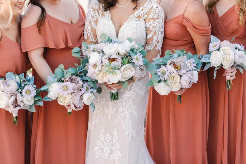 Close view of the bride and bridesmaids bouquets in cream, blush and eucalyptus