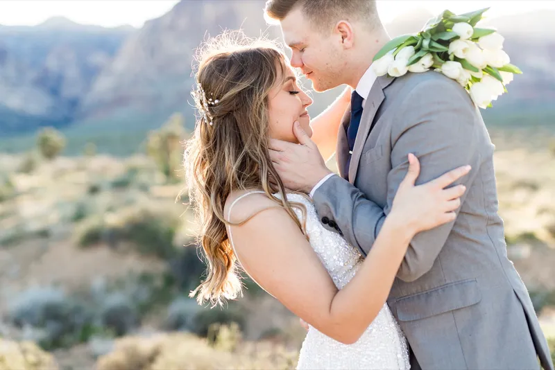 Close portrait of the couple kissing with her hand against his neck