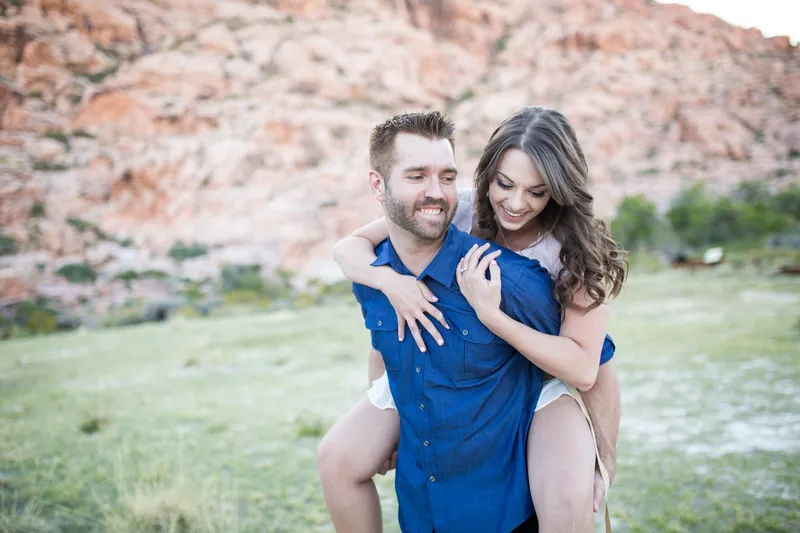 Couple piggyback riding in the desert near Las Vegas
