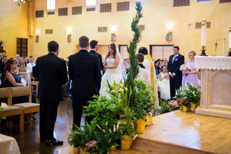 The couple and their wedding party gathered on the altar steps at the end of the ceremony