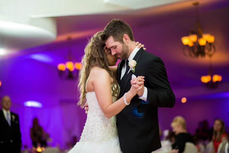First dance in the banquet room with the walls washed purple by uplighting