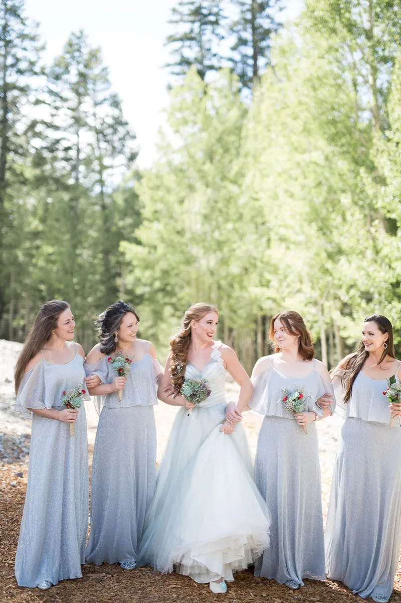 Bride and her bridesmaids walking together through the aspens with succulent bouquets