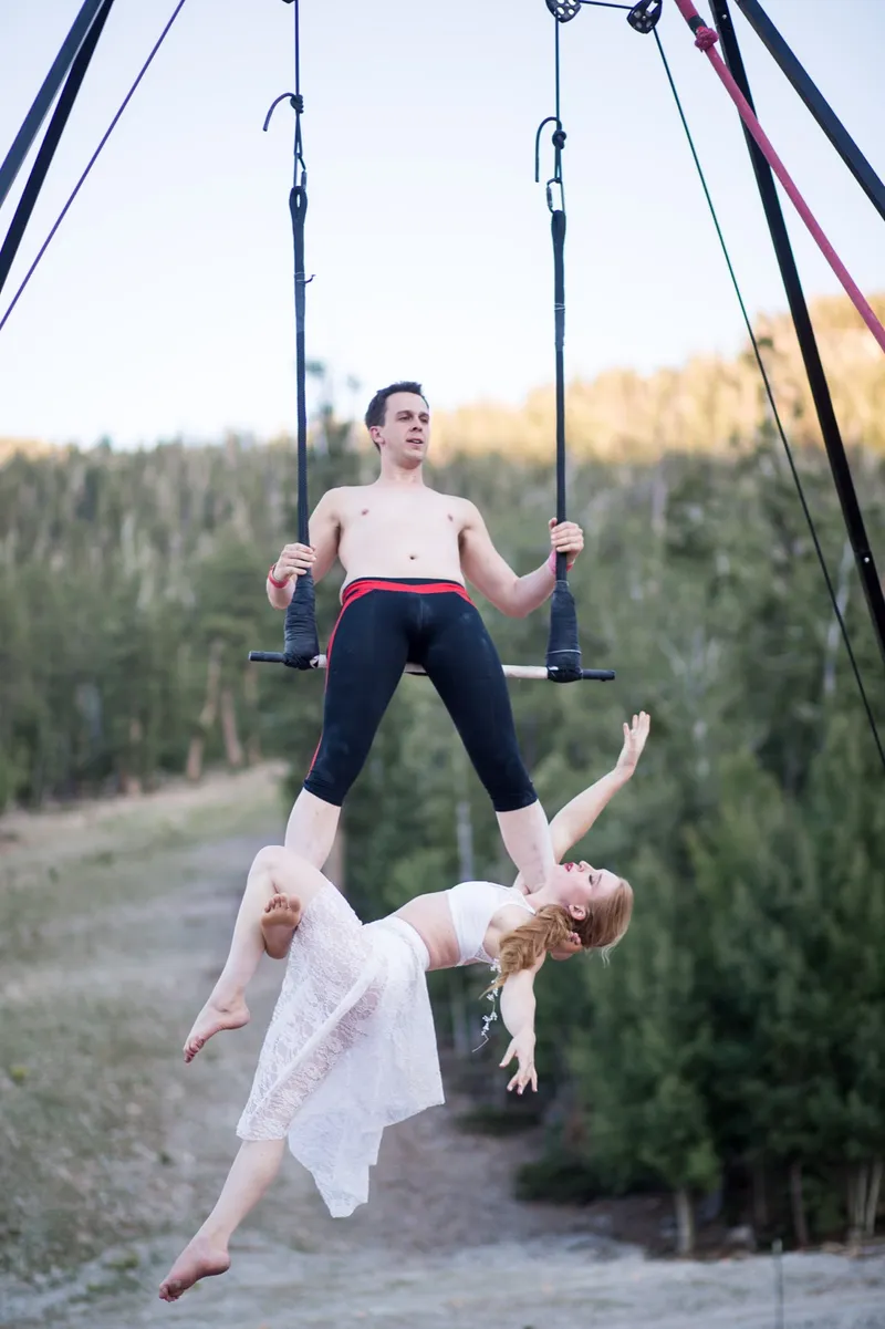 Aerial performers setting up on a rig at the reception as guests watch