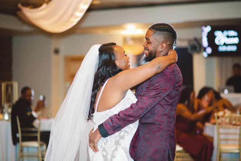 Couple holding each other on the dance floor in the middle of a song