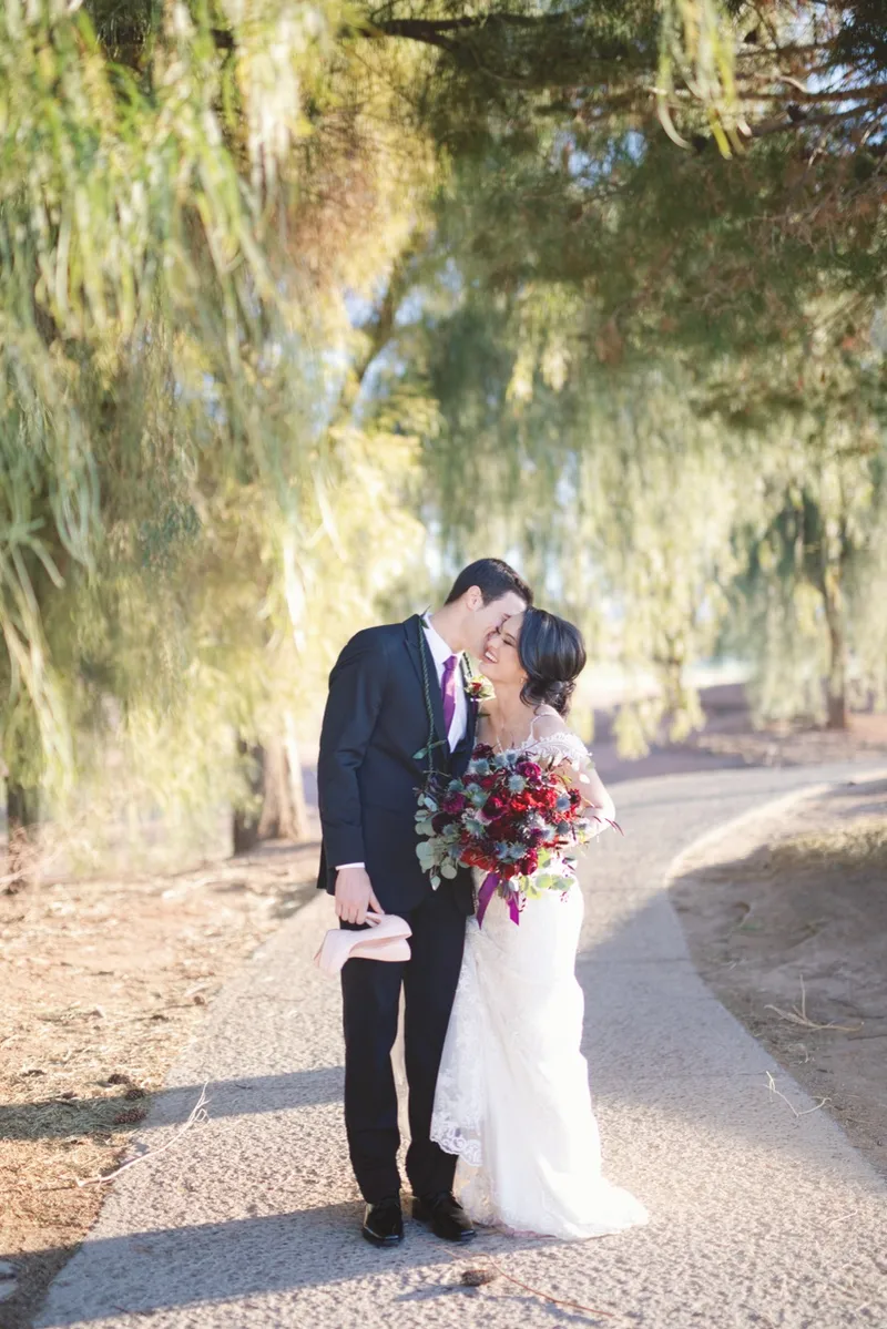Couple laughing together on the path in the shade of the trees