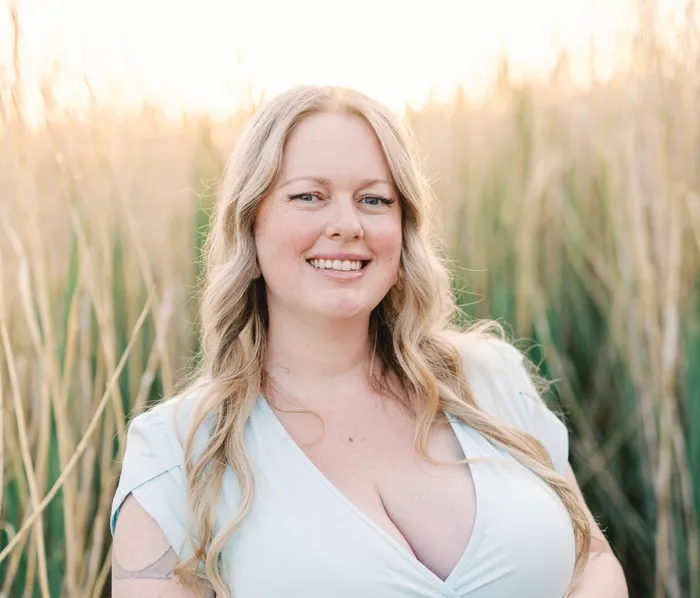 Michelle Brown, licensed Nevada officiant, smiling in a field of tall grass