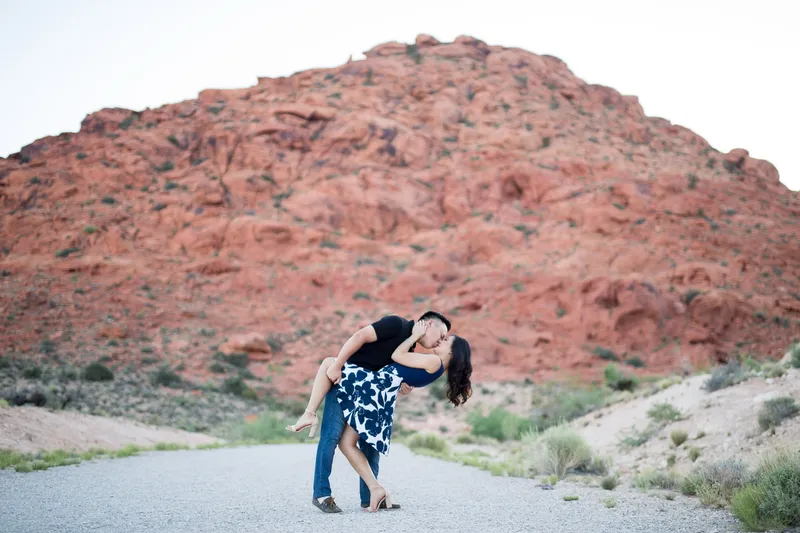Couple embracing in front of the red rocks at Valley of Fire