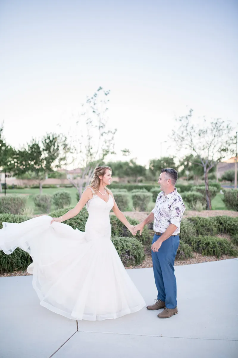 Couple dancing on the path with the bride's tulle skirt swinging wide around her