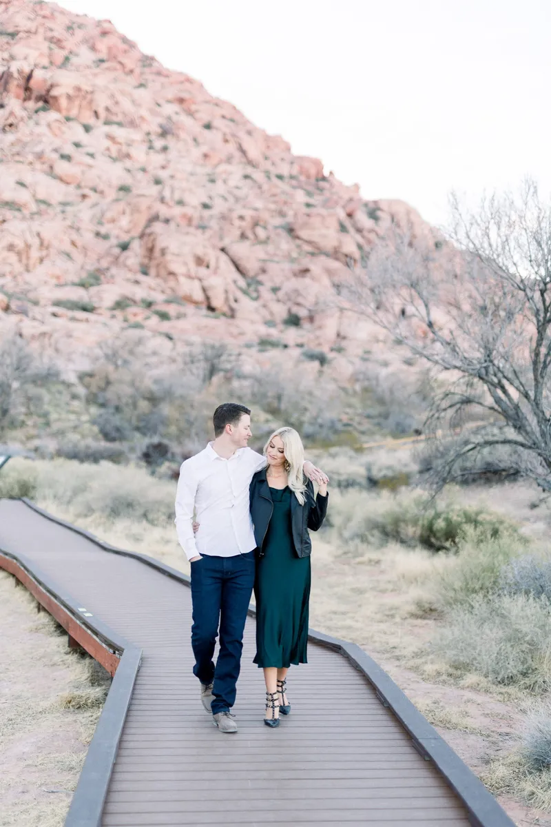 Couple walking through the desert at Red Rock in the evening light