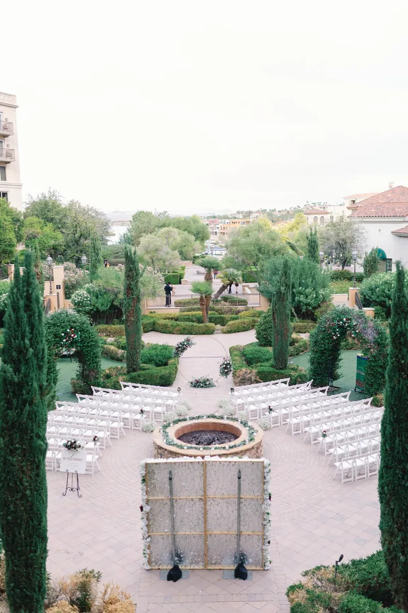 Wider view down onto the garden before guests arrive, cypress and clipped hedges on both sides of the aisle