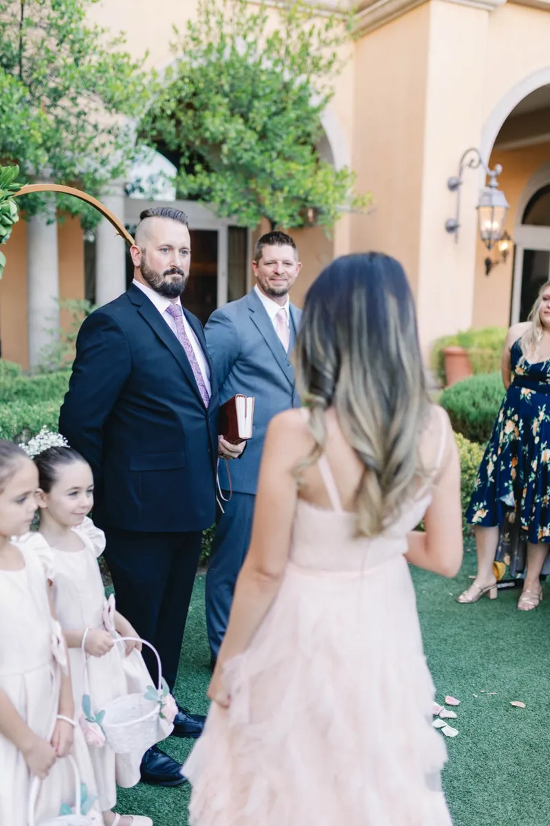 Bride reaching the front where the groom, the officiant and two flower girls are waiting for her