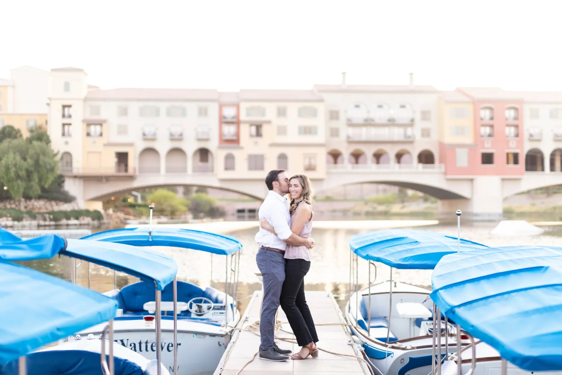 Newly engaged couple embracing on a dock at Lake Las Vegas