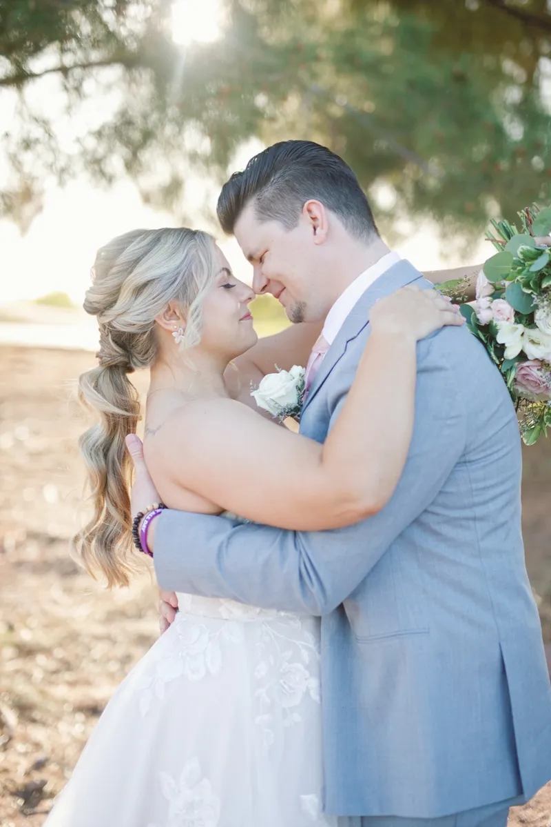 Couple touching foreheads in low golden light with the course going soft behind them