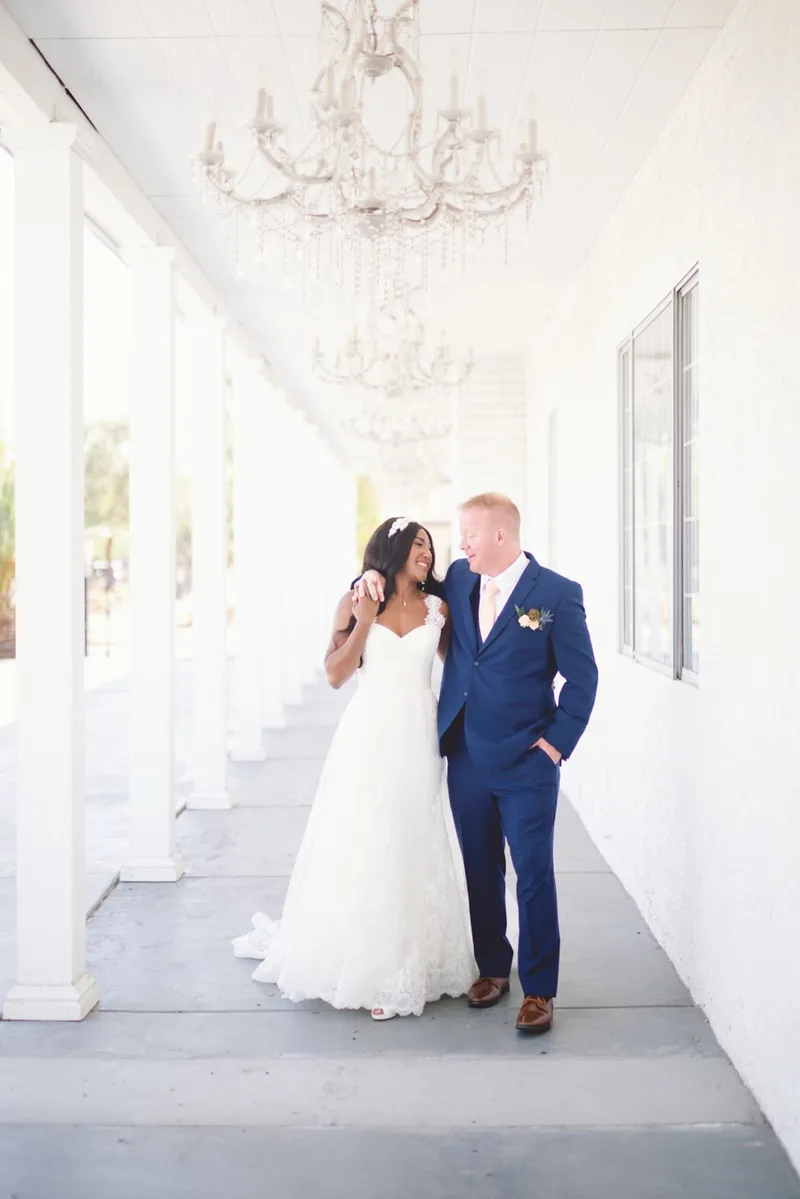 Couple walking together down the walkway, daylight coming in from the open side and lighting the length of it