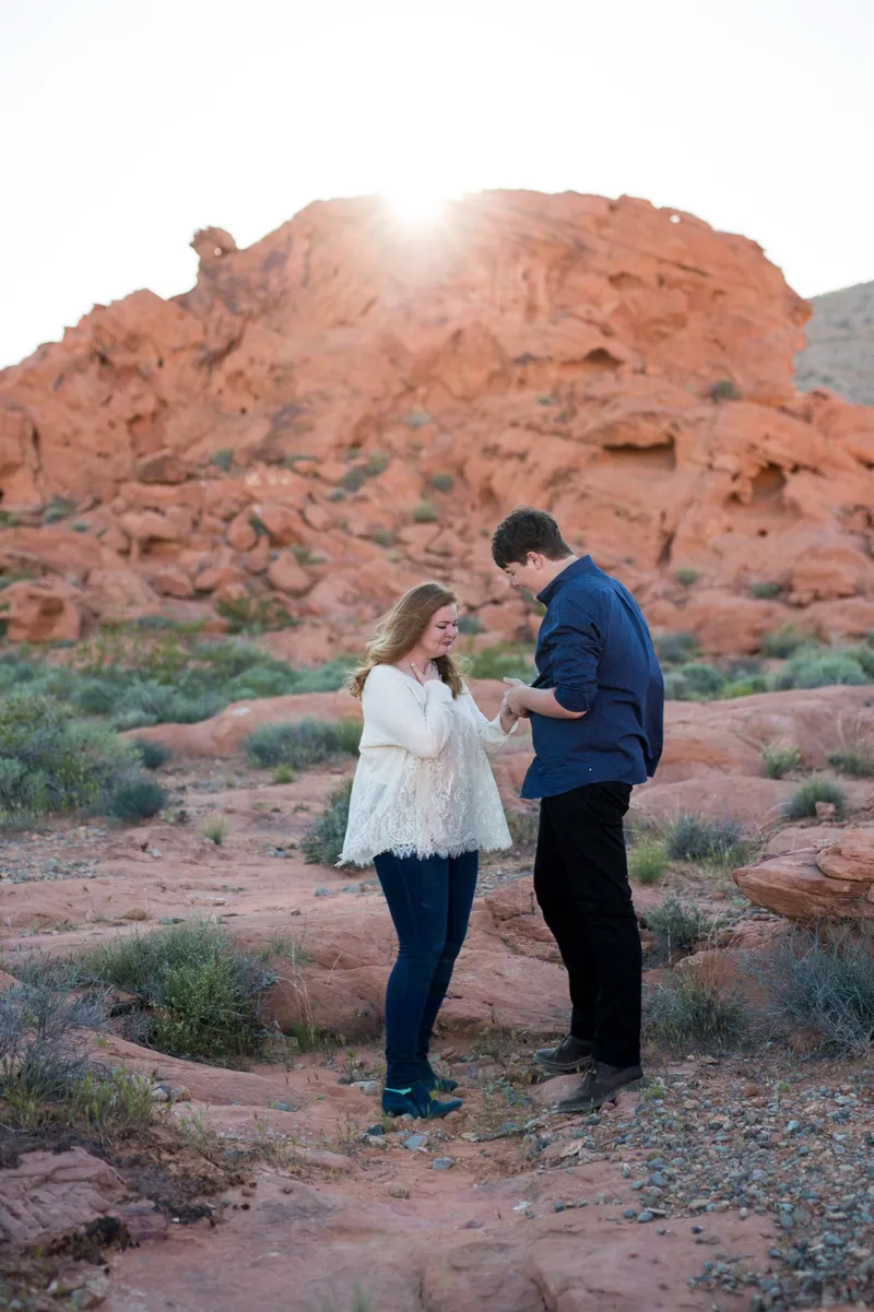 The two of them looking down together at the new ring on her hand