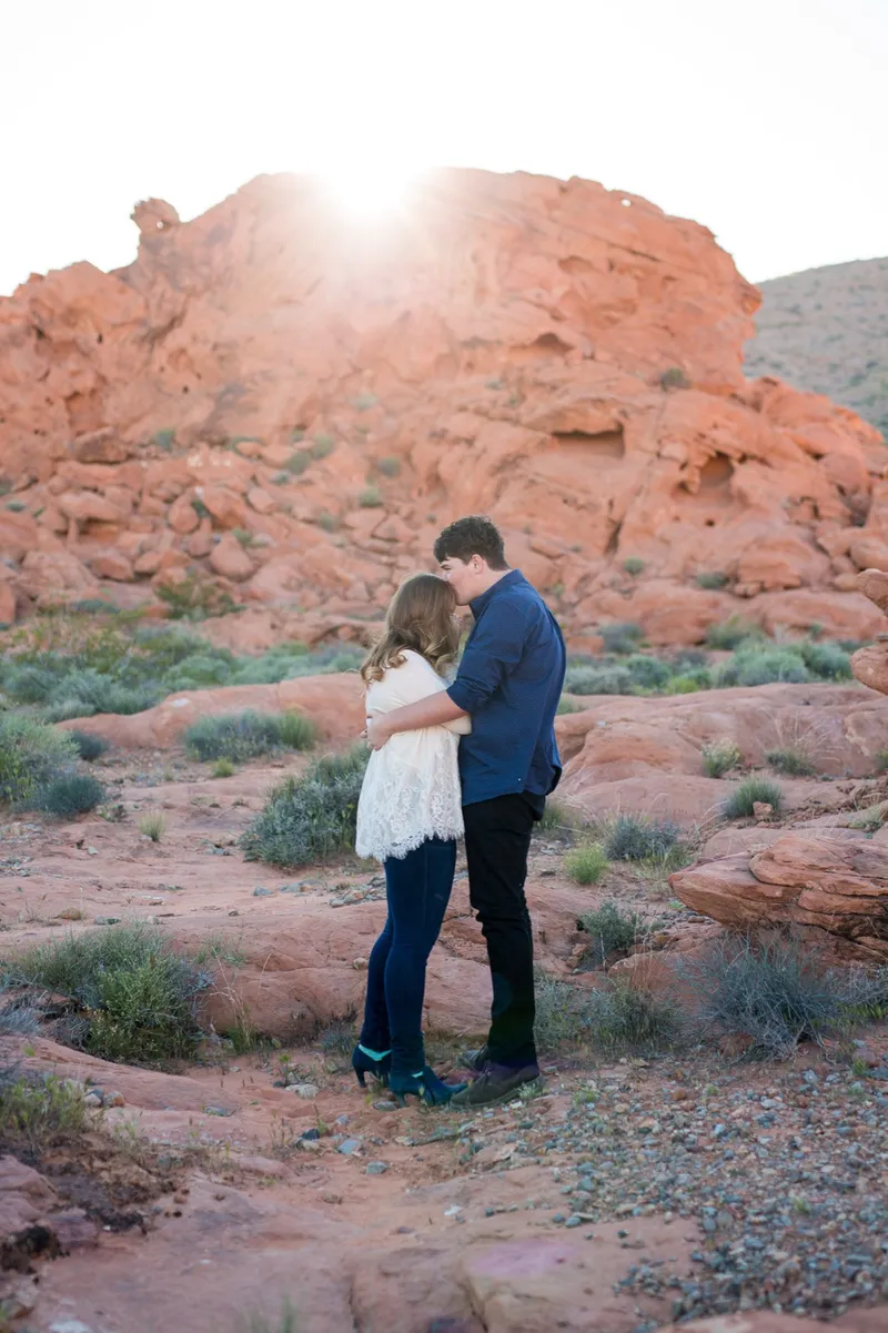 He holds her close with his face against her hair in the last of the sun