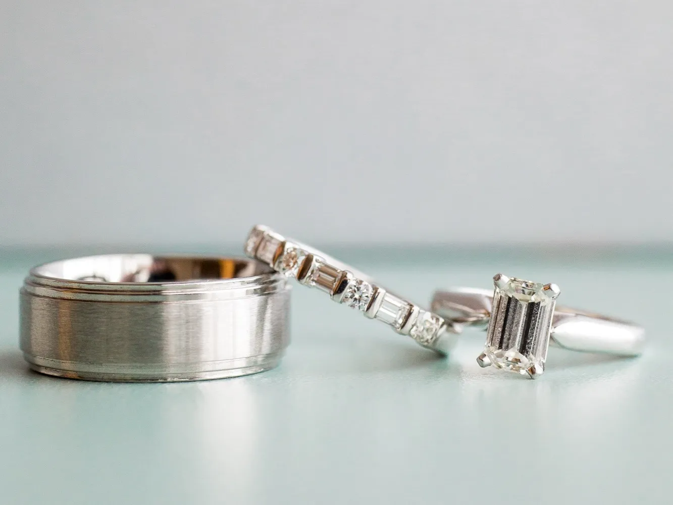 Wedding rings on a pale mint background